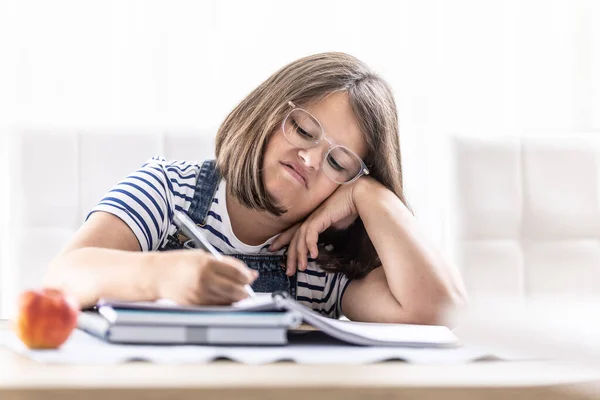 Annoyed Schoolgirl Eyewear Writes Homework Leaning Her Hand — Fotografia de Stock