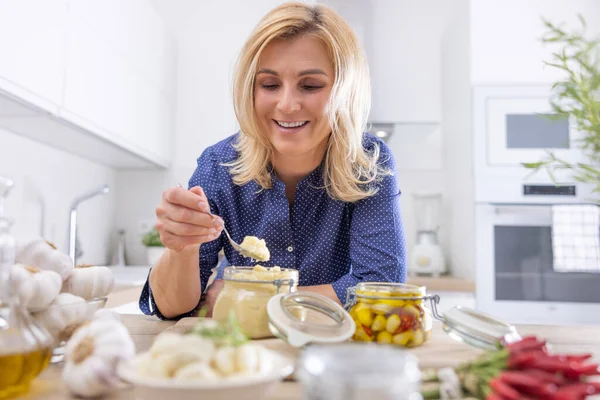 Sniling Donna Bionda Raccoglie Cucchiaino Aglio Schiacciato Vaso Cucina — Foto Stock