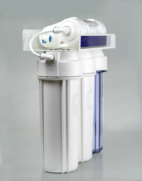 Home water filtration system with carbon filters and membrane. On a grey background.
