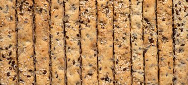 Keten ve susam tohumlu ekmek çubuklarının arka planı.