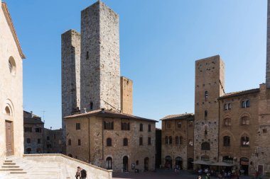 San Gimignano, İtalya-Ağustos 8.2020: Saint Gimignano 'da gezinmek ve güneşli bir günde ünlü ortaçağ kulelerine hayran olmak..