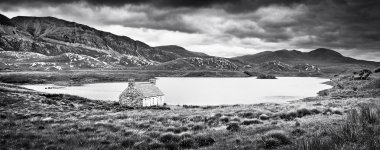Dramatic landscape with old stone house at a lake on Isle of Mull, Scotland clipart