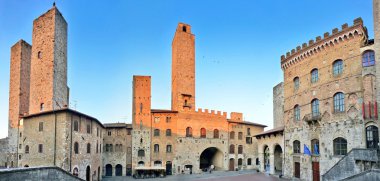 Panoramic view of famous Piazza del Duomo in San Gimignano at sunset, Tuscany, Italy clipart