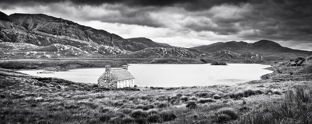 Dramatic landscape with old stone house at a lake on Isle of Mull, Scotland