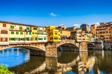 Famous Ponte Vecchio with river Arno at sunset in Florence, Italy clipart