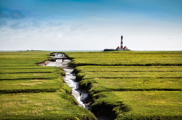 Beautiful landscape with famous Westerheversand lighthouse in the background at North Sea in Nordfriesland, Schleswig-Holstein, Germany