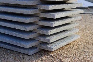 Concrete slabs stacked on top of each other. Stack of gray tiles. 