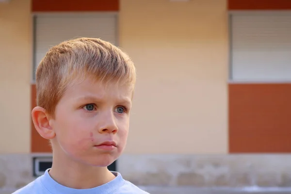 Een Blonde Jongen Met Een Vies Gezicht Staart Aandachtig Verte — Stockfoto