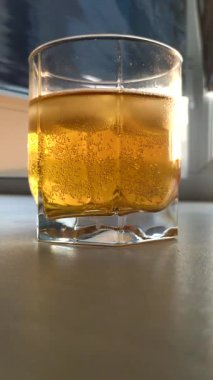 Timelapse Beer with ice in a glass, bubbles in a glass with beer