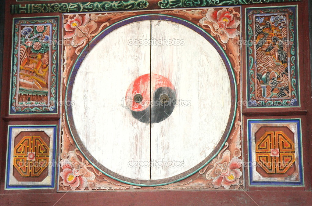 Yin-yang symbol in polychrome wooden door.