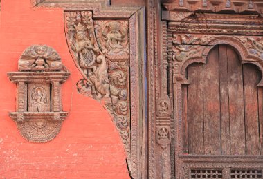Carved wooden door in Patan. clipart