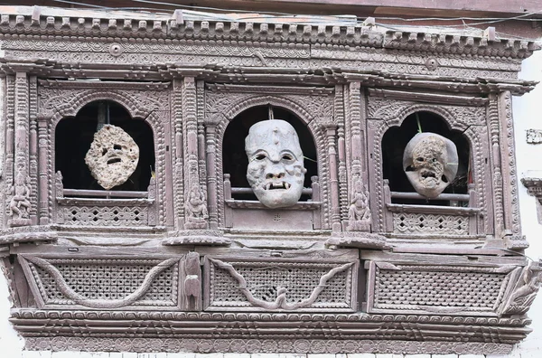 0194 Masks hanging on carved window. Durbar Square-Kathmandu-Nepal. — Stock Photo, Image