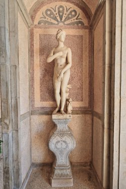 Anonymously carved plaster copy of the Medici Venus Hellenistic statue placed in the garden in 1909 -thus copyright expired- depicting Aphrodite-Greek goddess of love. Estoi palace-Algarve-Portugal. clipart