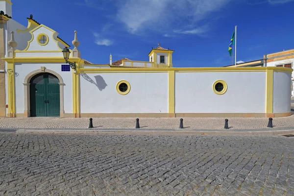 ブラジル総領事館の中庭の白化と黄色のエッジの外壁は セット舗装されたルア アルベルグ通りに与える旗を振って緑の木の扉を閉じました ファロ アルガルヴェ ポルトガル — ストック写真