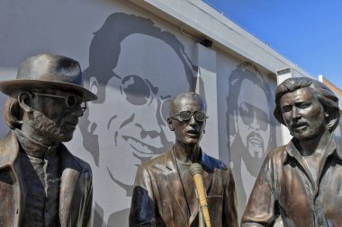 Redcliffe, Australia-October 3, 2018: The Bee Gees way is an open-air laneway off Redcliffe Parade hosting a 70 m.mural of photos of the brothers and life-size statues of them as boys and as adults.