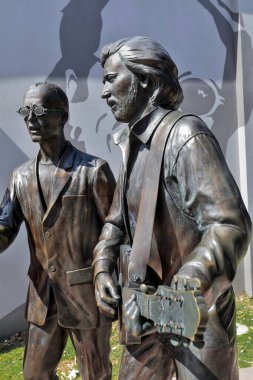 Redcliffe, Australia-October 3, 2018: The Bee Gees way is an open-air laneway off Redcliffe Parade hosting a 70 m.mural of photos of the brothers and life-size statues of them as boys and as adults.