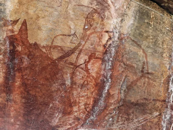 Ancestral Aboriginal rock art: Mimi spirits and fish painting-red ochre and animal blood-Mountford or Northern Running Figures group dated by archaeologists c.5000 years old. Ubirr-Kakadu-NT-Australia