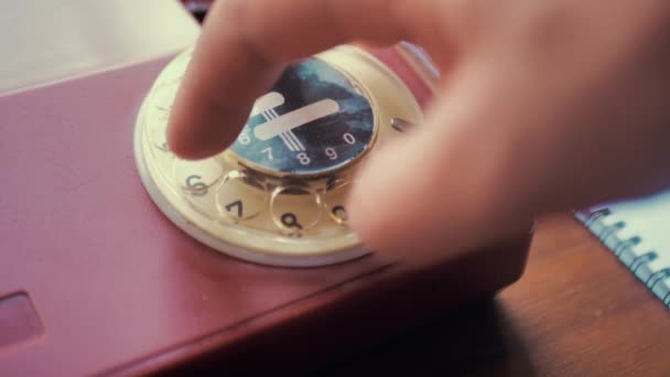 Ringing a red Rotary dial telephone. Dialing on an old rotary style telephone. Red vintage phone. retro phone ringing off the hook — Stock Video