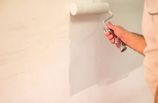 Decorators hand painting wall with roller — Stock Photo, Image