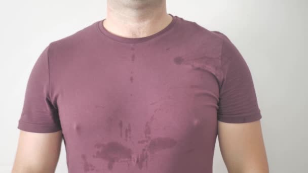 Man with a stain of sweat on it. He sweats from the heat. Problem with hyperhidrosis — Stock Video