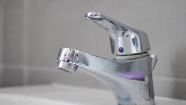 Keran di kamar mandi dengan air mengalir. Manusia terus mematikan air untuk menghemat energi air dan melindungi lingkungan. — Stok Video