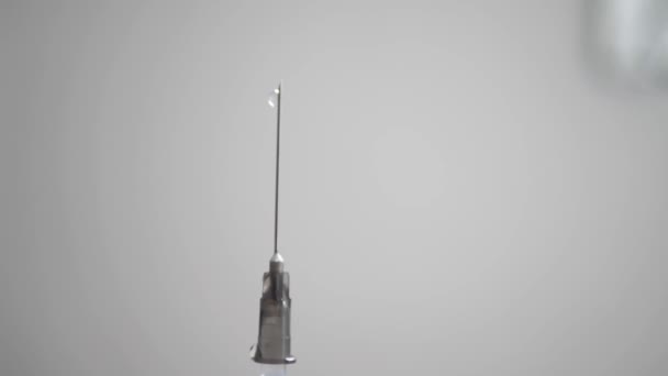 Selective focus on an injection syringe in a human hand on a white background — Wideo stockowe