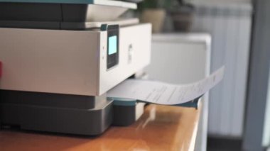 Laser printer operation. Closeup of paper printing