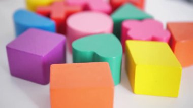 multi-colored wooden blocks on a white table background, close-up. Business concept