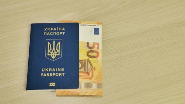 Ukrainian biometric passport id to travel the Europe without visas on the table, Inscription in Ukrainian Ukraine Passport