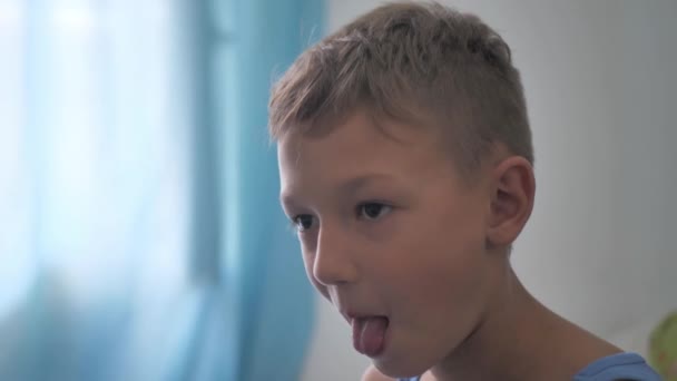 Boy Shows His Tongue Looks Camera Gestures His Mouth Tongue — Stockvideo