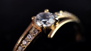 a brilliant round diamond in a ring. on a black background, Close-up top view