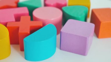 multi-colored wooden blocks on a white table background, close-up. Business concept