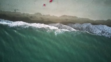 4K Aerial Front View. Beach, sea, sand and palms. Drone view of a beautiful white tropical sand beach on a summer day. Top view empty and clean beach