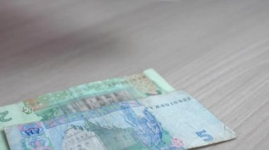 A woman counts Ukrainian currency - hryvnias, banknotes close-up. Salary or other income. Cash money concept