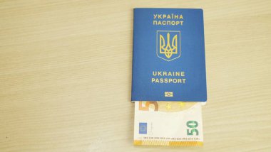 Ukrainian international biometric passport and bag for travel close up,Translation from Ukrainian Ukraine,passport