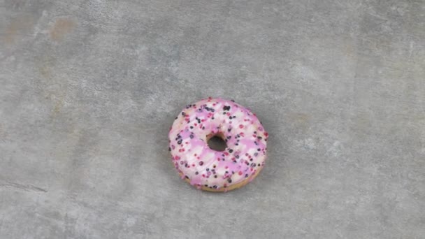 Close Bright Colorful Sprinkled Donut Rotating Gray Background View — Stock Video