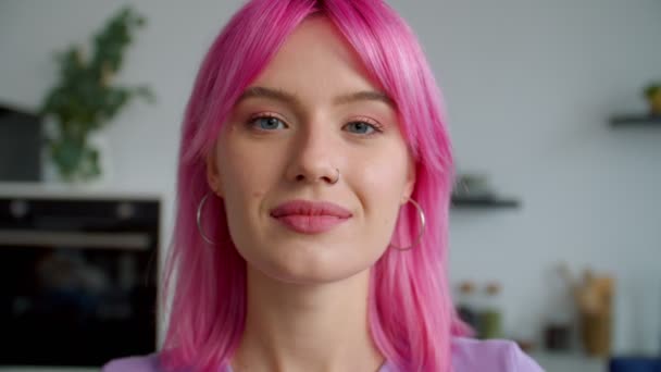 Closeup portrait of beautiful pink haired young woman flirting indoors — Stock Video