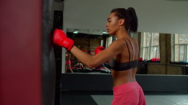 Breathless exhausted black woman fighter resting on punching bag after training — Vídeo de Stock