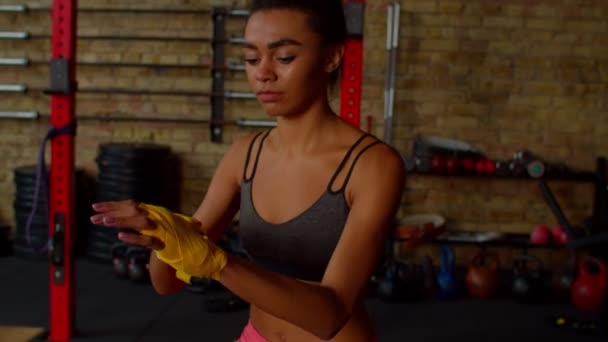 Determined sporty fit African American woman boxer preparing for fight — Stockvideo
