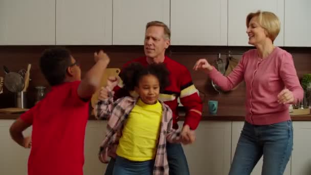 Joyful grandparents and carefree multiracial kids having fun dancing at home — Wideo stockowe