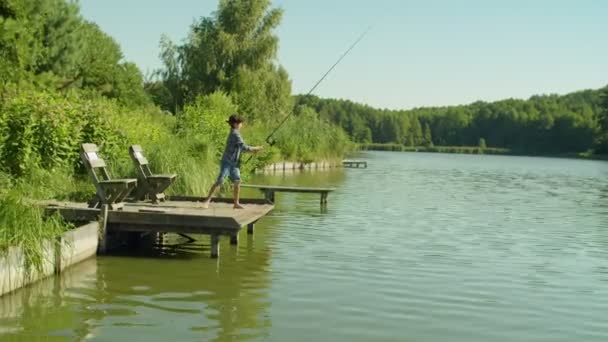 Relaxed Adorable Arab Teenage Fisherman Fishing Wooden Jetty Pond Casting — Stockvideo