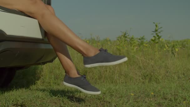 Close Slim Beautiful Female Legs Canvas Shoes Dangling Car Trunk — Stok video