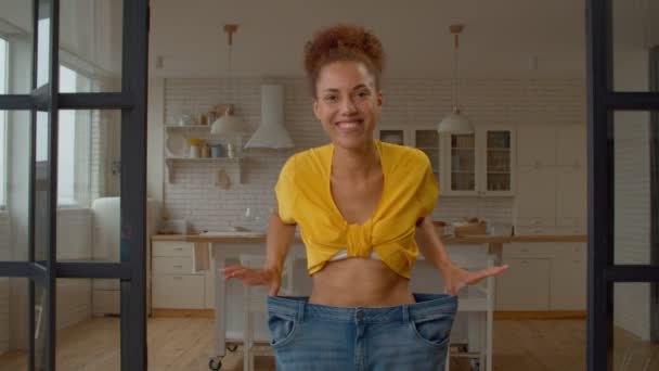 Joyful Happy Charming Black Woman Oversized Jeans Demonstrating Results Successful — Stock Video