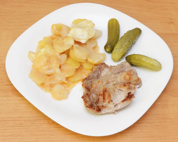 Fried steak, potato and pickles. — Stock Photo, Image