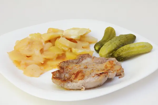Fried steak, potato and pickles. — Stock Photo, Image