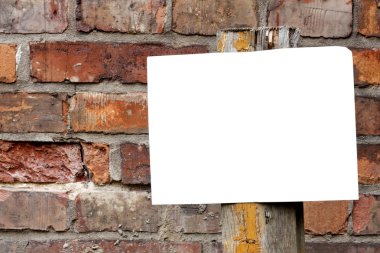 Empty blank plate on brick wall clipart