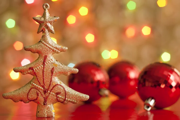 Christmas tree and baubles against blurred colorful background Stock Image