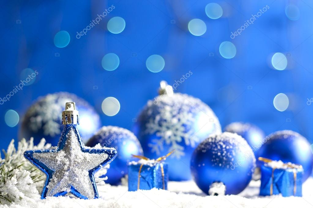 Christmas star closeup and baubles on blue blurred background