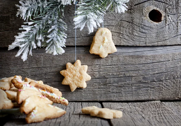 Weihnachtsgebäck auf Holzbrettern mit Tannenhintergrund — Stockfoto