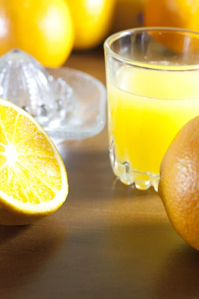 Sumo fresco de laranja com espremedor na mesa — Fotografia de Stock